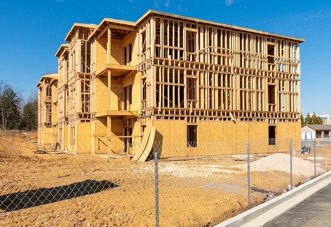 a close-up of temporary chain link fences enclosing a construction site, signaling progress in the project's development in New Haven MI